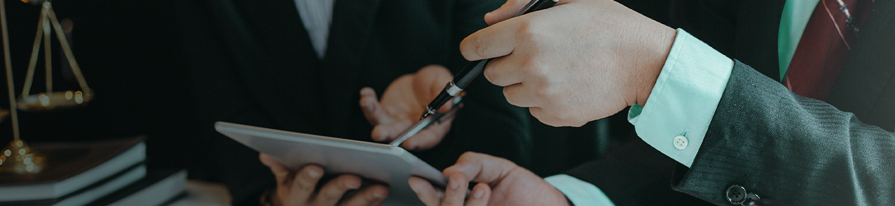 Men in meeting holding tablet